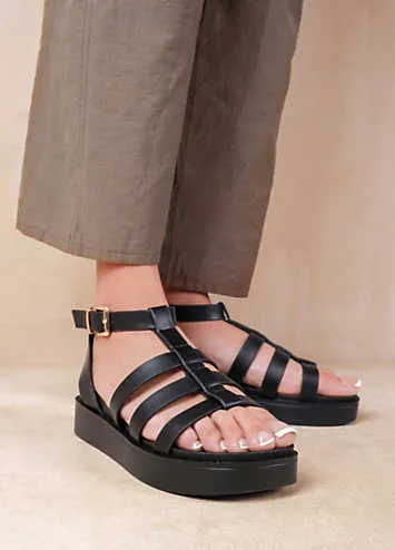 Where’s That From Dubai Extra Wide Fit Mid Platform Gladiator Strap Sandals in Black PU | Grattan