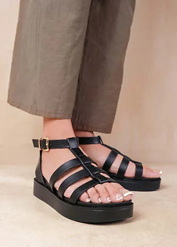 Where’s That From Dubai Extra Wide Fit Mid Platform Gladiator Strap Sandals in Black PU | Kaleidoscope